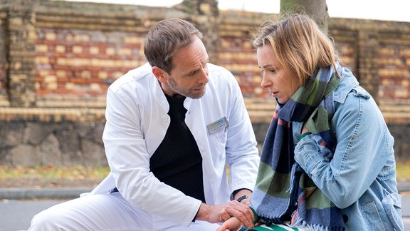 Dr. Kai Hoffmann (Julian Weigend) findet hinter der Klinik Sally Kuhn (Friederike Linke) mit starken Atemproblemen.