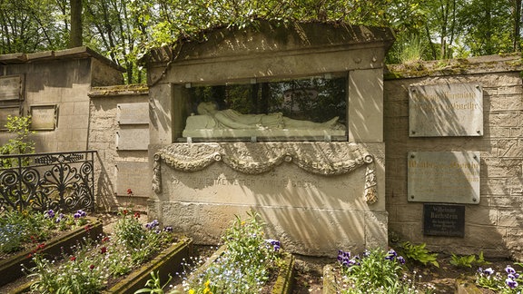 Grabstätte der Familie Goethe in Weimar: ein großer Stein mit einem Sichtfenster, hinter dem eine Statue liegt