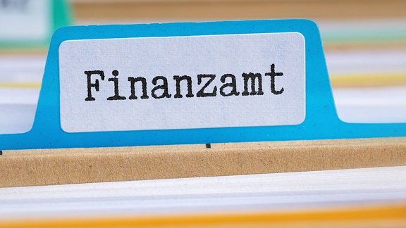 Ein Schild "Finanzamt" an Unterlagen.