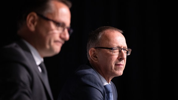 Tino Chrupalla (l), AfD-Bundesvorsitzender und Fraktionsvorsitzender der AfD, sitzt vor Beginn des Landesparteitag seiner Partei im Messe- und Veranstaltungspark Löbau neben Jörg Urban, Vorsitzender der AfD in Sachsen.