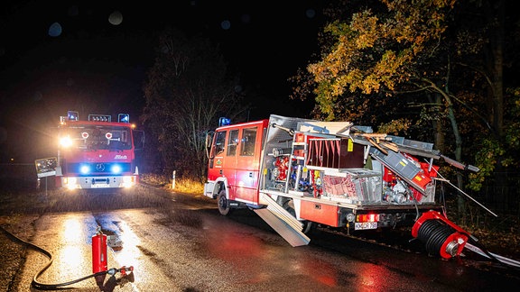 Ein beschädigtes Löschfahrzeug steht am Straßenrand, ein zweites Feuerwehrauto ist zu Hilfe gekommen.