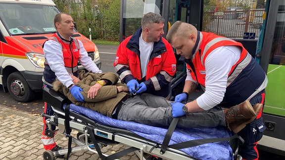 Rettungskräfte helfen einem Mann bei einer Rettungsübung