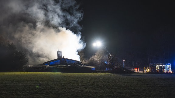 Feuerwehrleute löschen einen Wohnhausbrand