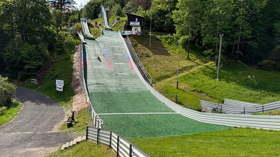 Eine Skisprungschanze im Sommer.